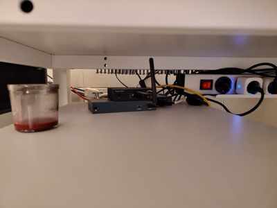 Mini PC, Wi-Fi antenna and power strip tucked under a shelf