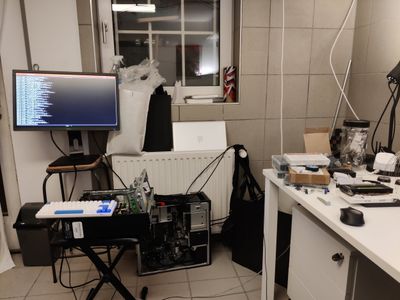 Opened PC and a monitor on a workbench in a workshop