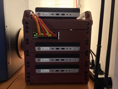 10-inch mini rack holding a stack of mini PCs, with bundled patch cables
